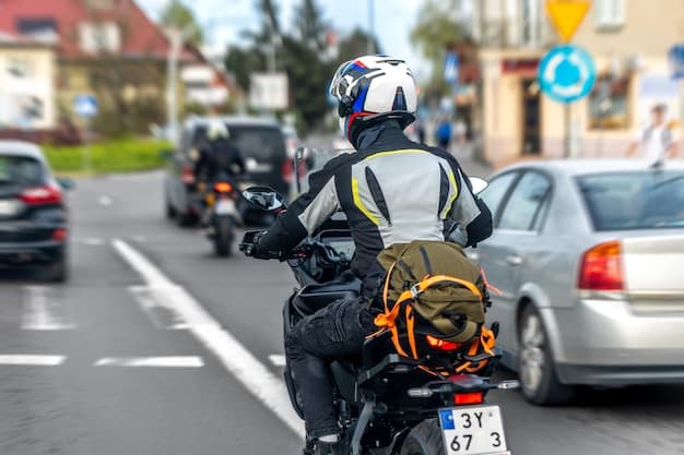 A motorcyclist with a helmet riding through city traffic
